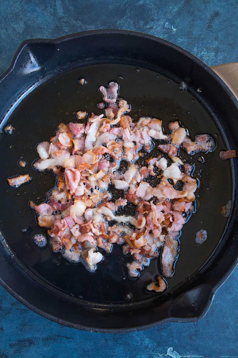 Cooking bacon in a big skillet.