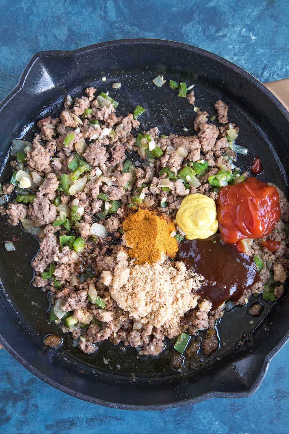 Adding the sauces and seasonings to the pan.