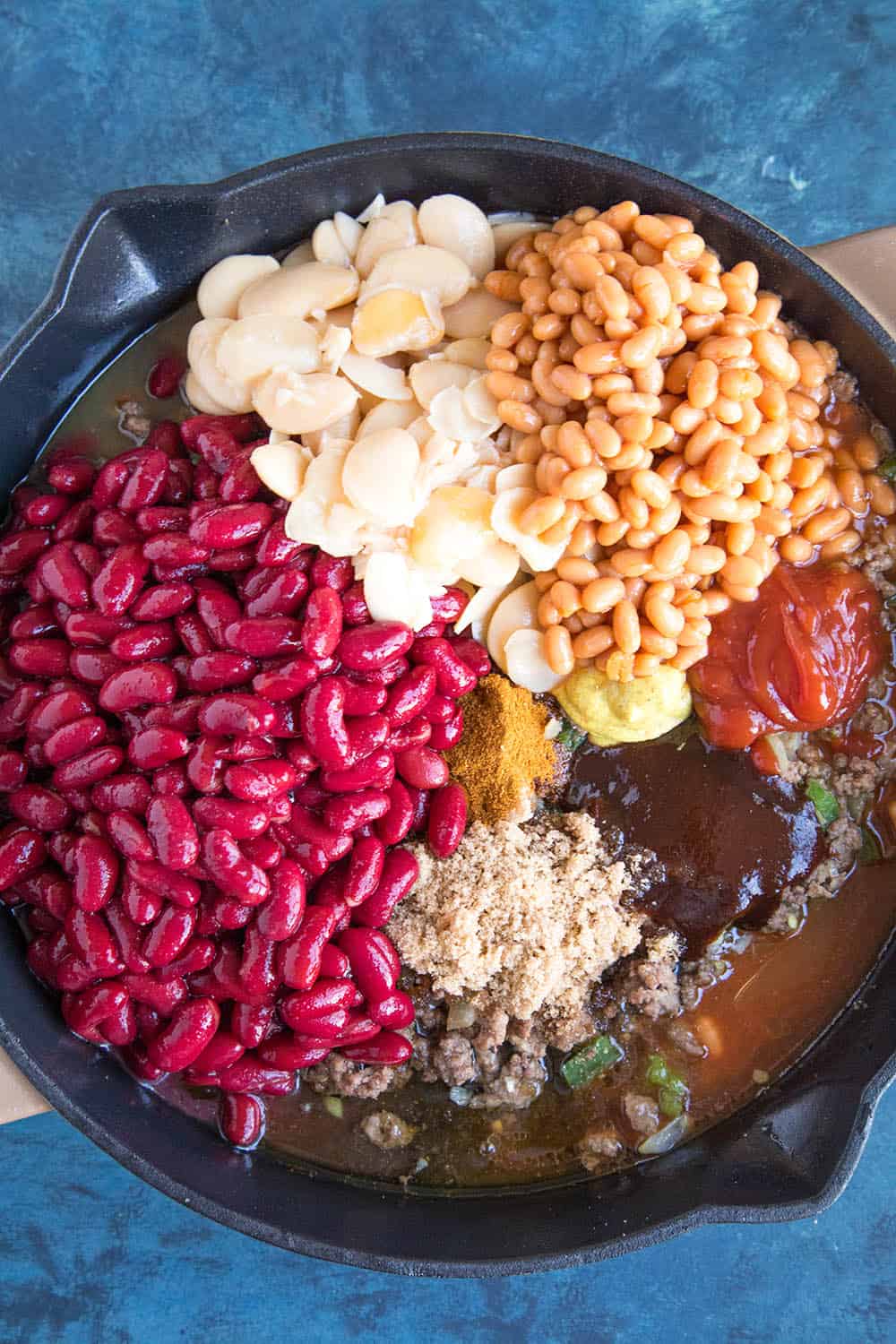 Adding the beans to the pan.