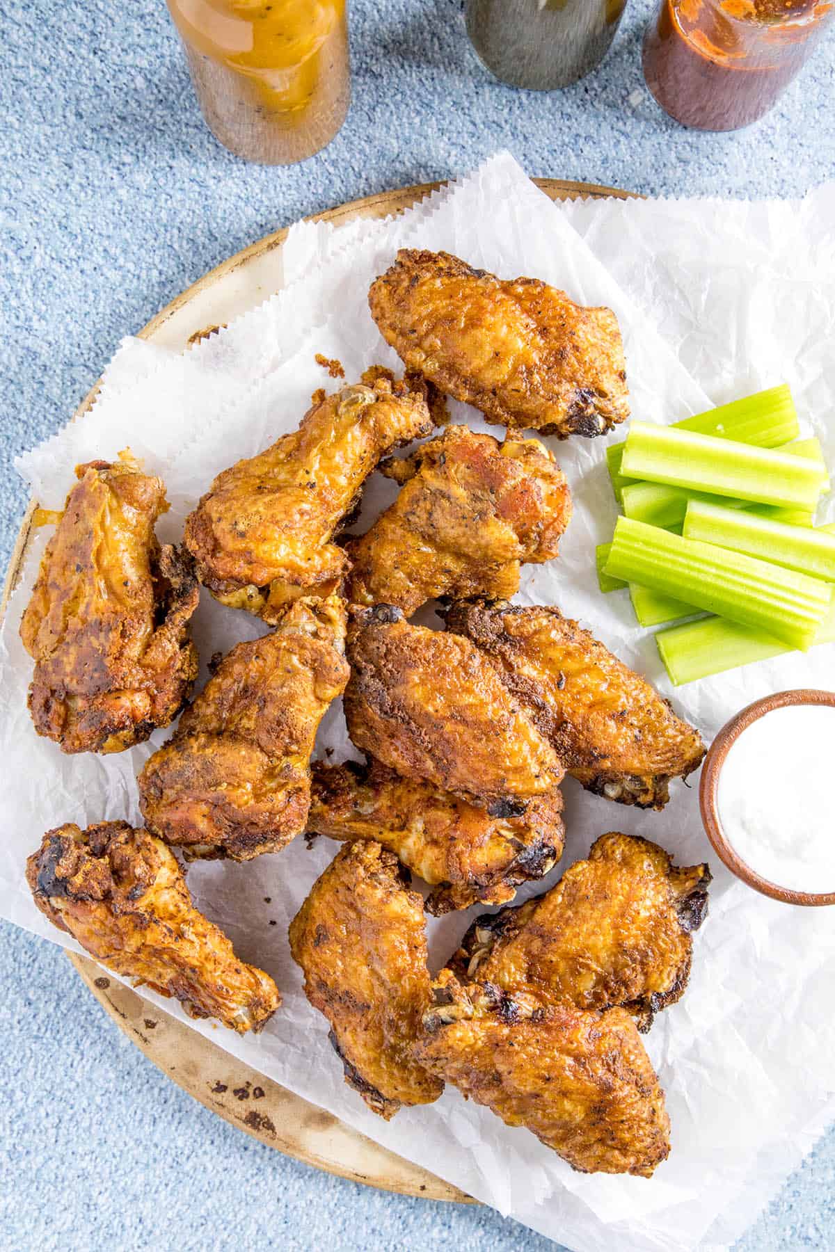 Crispy Baked Chicken Wings on a platter, served with hot sauce, celery and ranch dressing