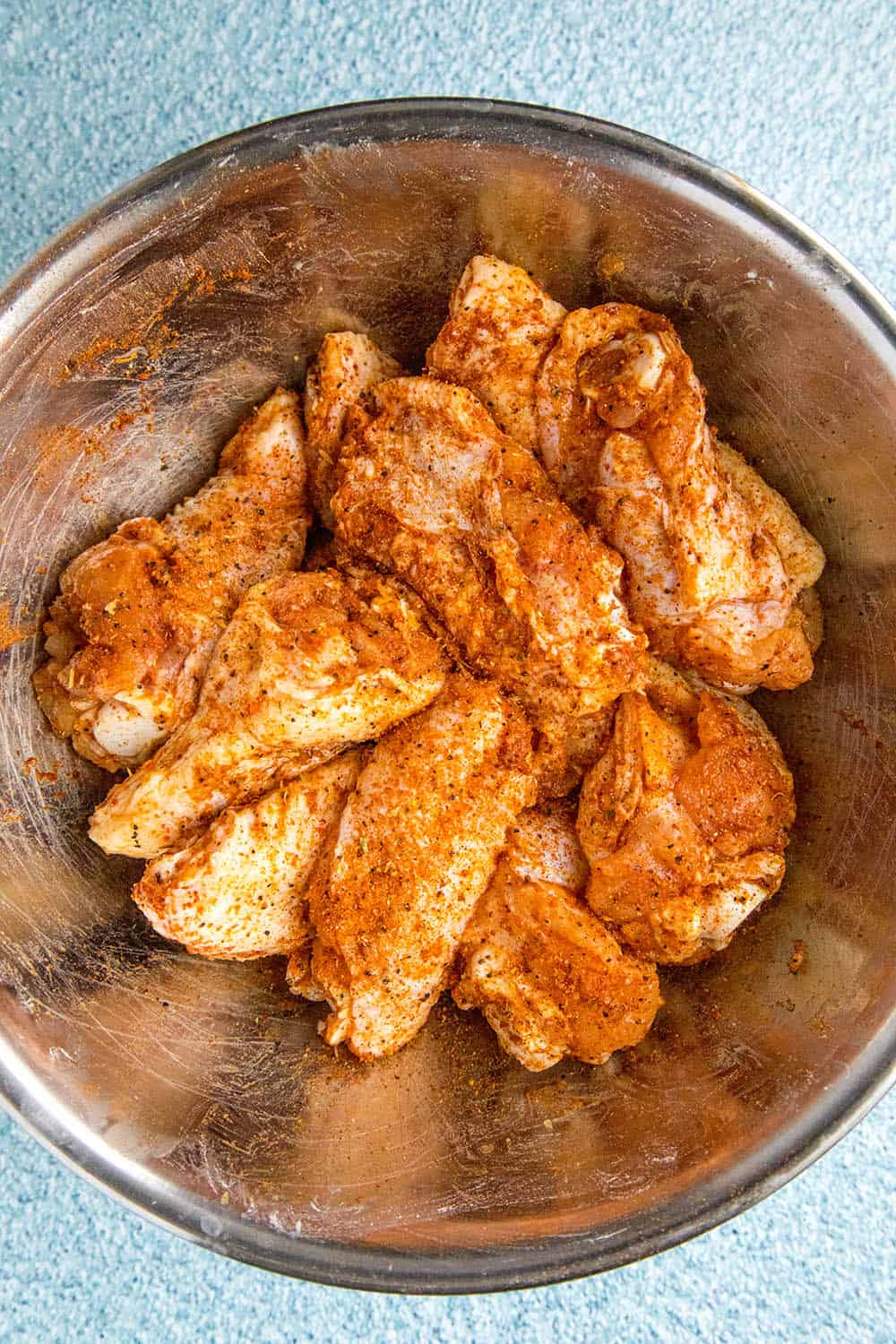 Seasoning the wings with my favorite Cajun seasoning blend