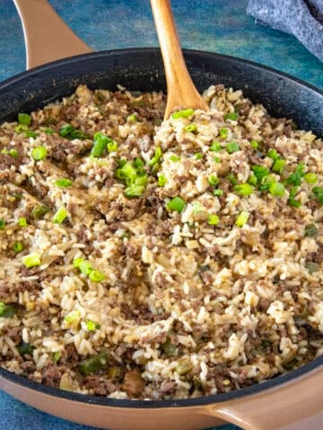 Mike serving a scoop of Cajun Dirty Rice from the hot pan