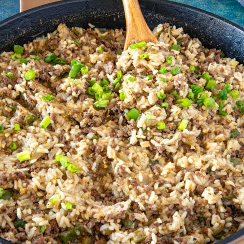 Mike serving a scoop of Cajun Dirty Rice from the hot pan