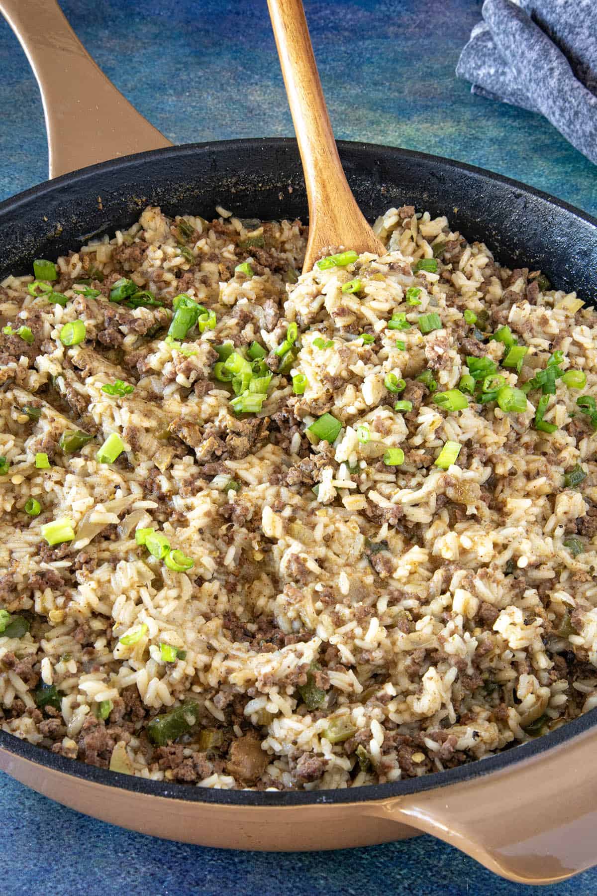 Mike serving a scoop of Cajun Dirty Rice from the hot pan