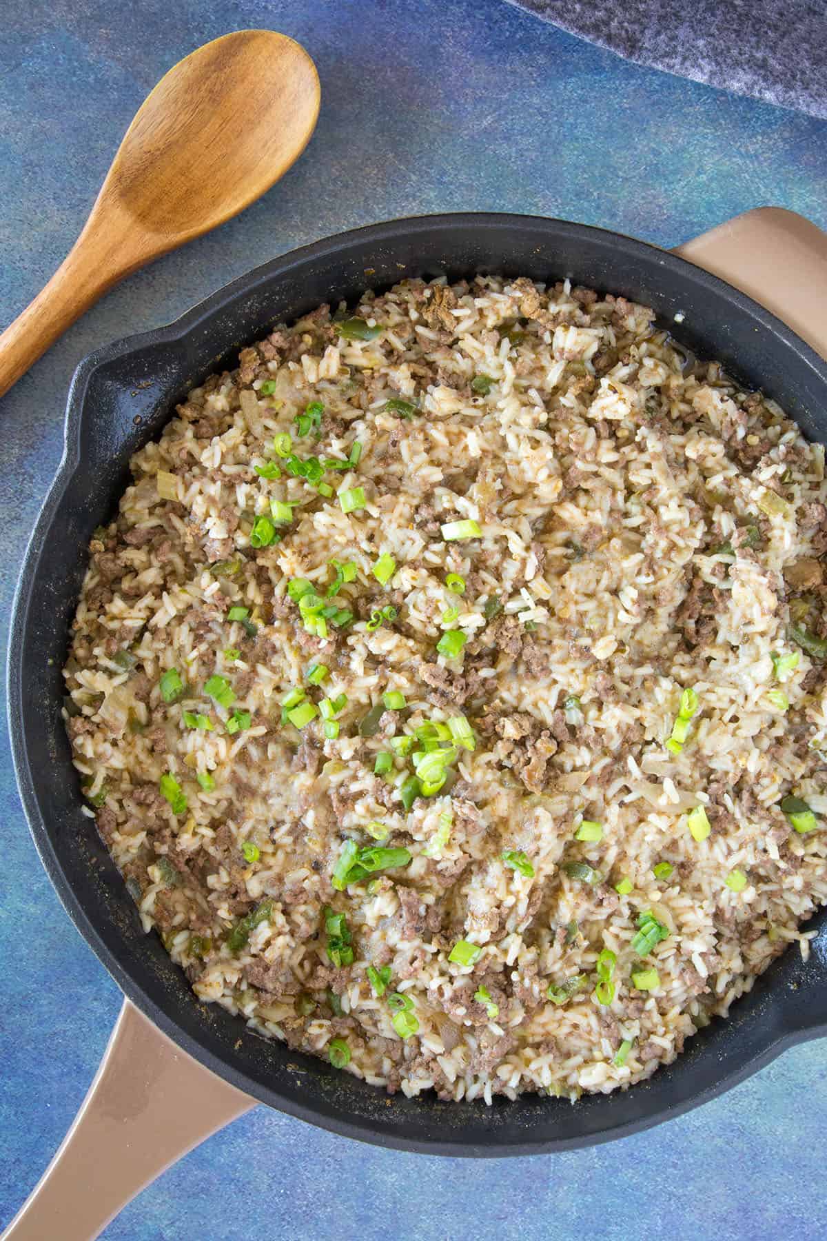 Dirty Rice in a pan, with garnish