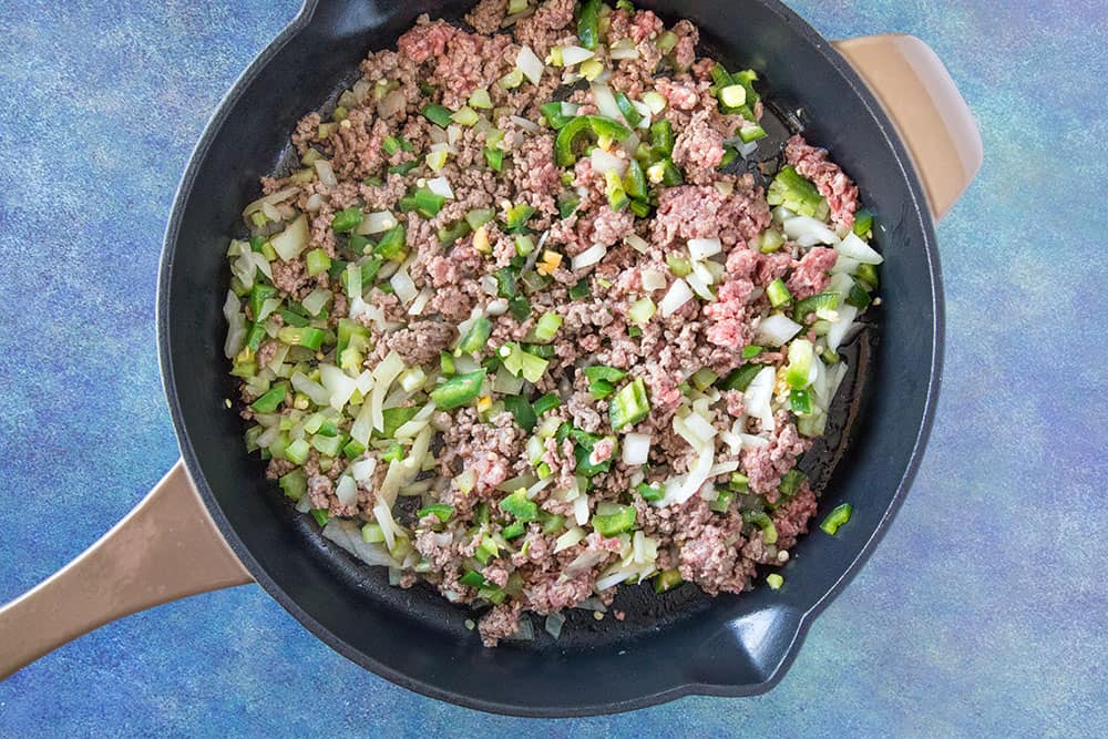 Cook down the ground beef and chicken livers with peppers, onion and celery