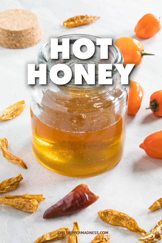 Hot Honey Recipe - This hot honey recipe infuses honey with a mixture of fresh habanero peppers and spicy dried red peppers for a spicy honey you\'ll love. Works with any chili pepper. #Honey #SweetSauce #HotSauce