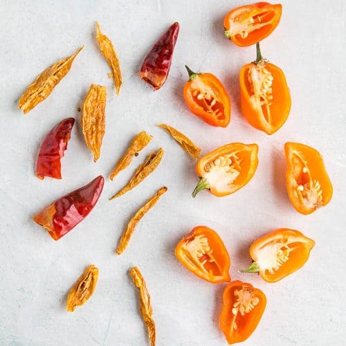 Fresh habanero peppers and dried spicy red peppers used to infuse honey with heat and flavor