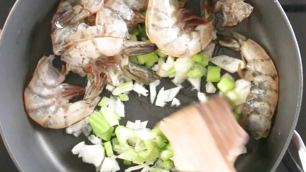 Cooking down the vegetables and shrimp shells to make seafood stock