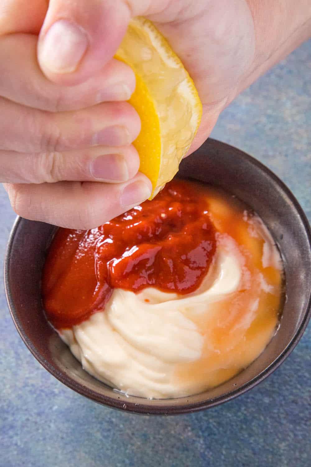 Squeezing lemon juice into the Sriracha Mayo