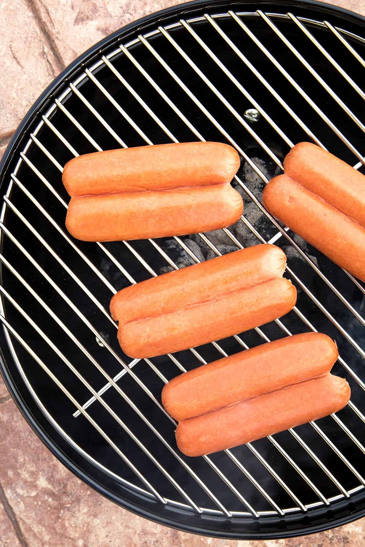 Split hot dogs on the grill