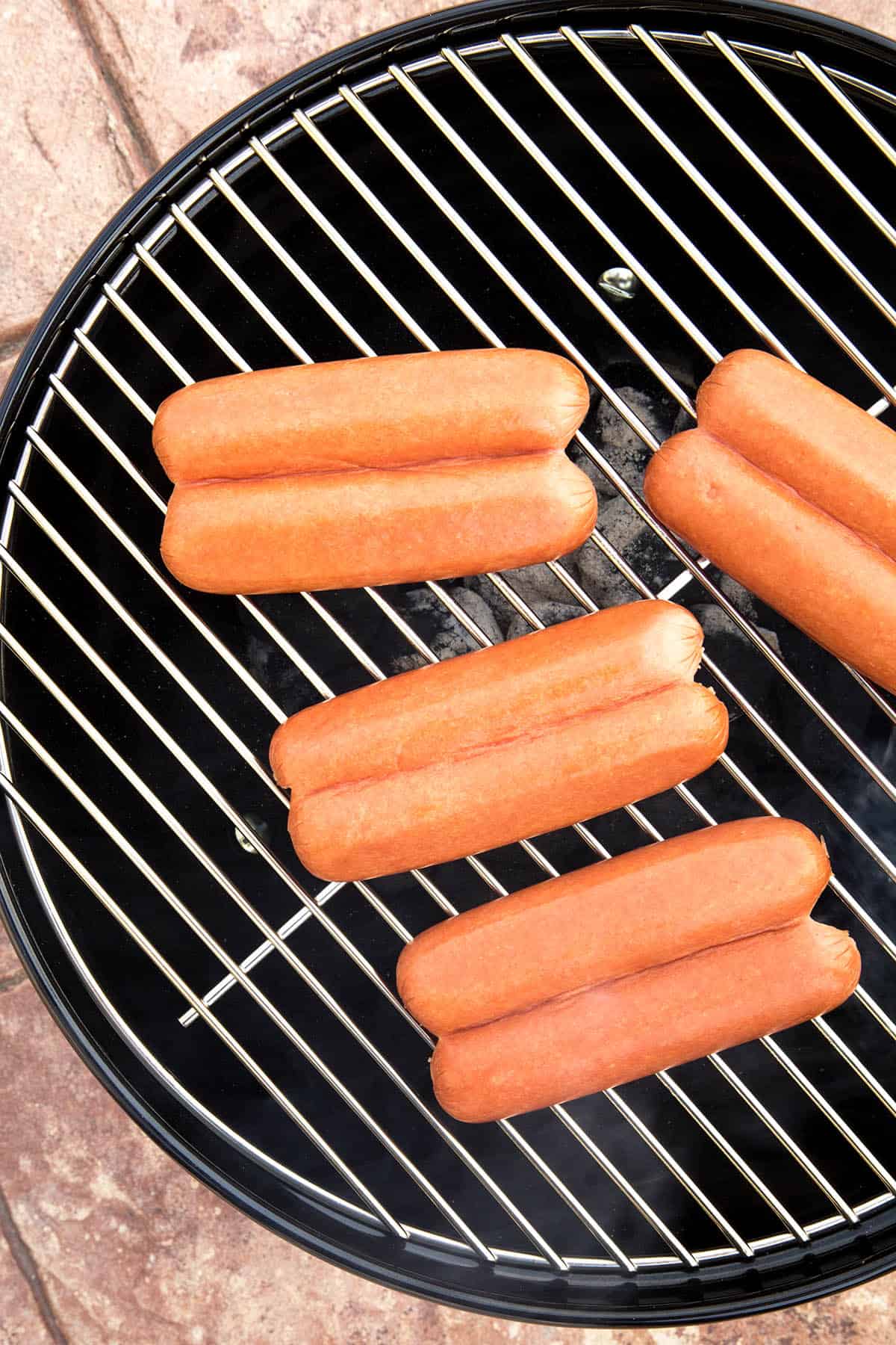 Split hot dogs on the grill.