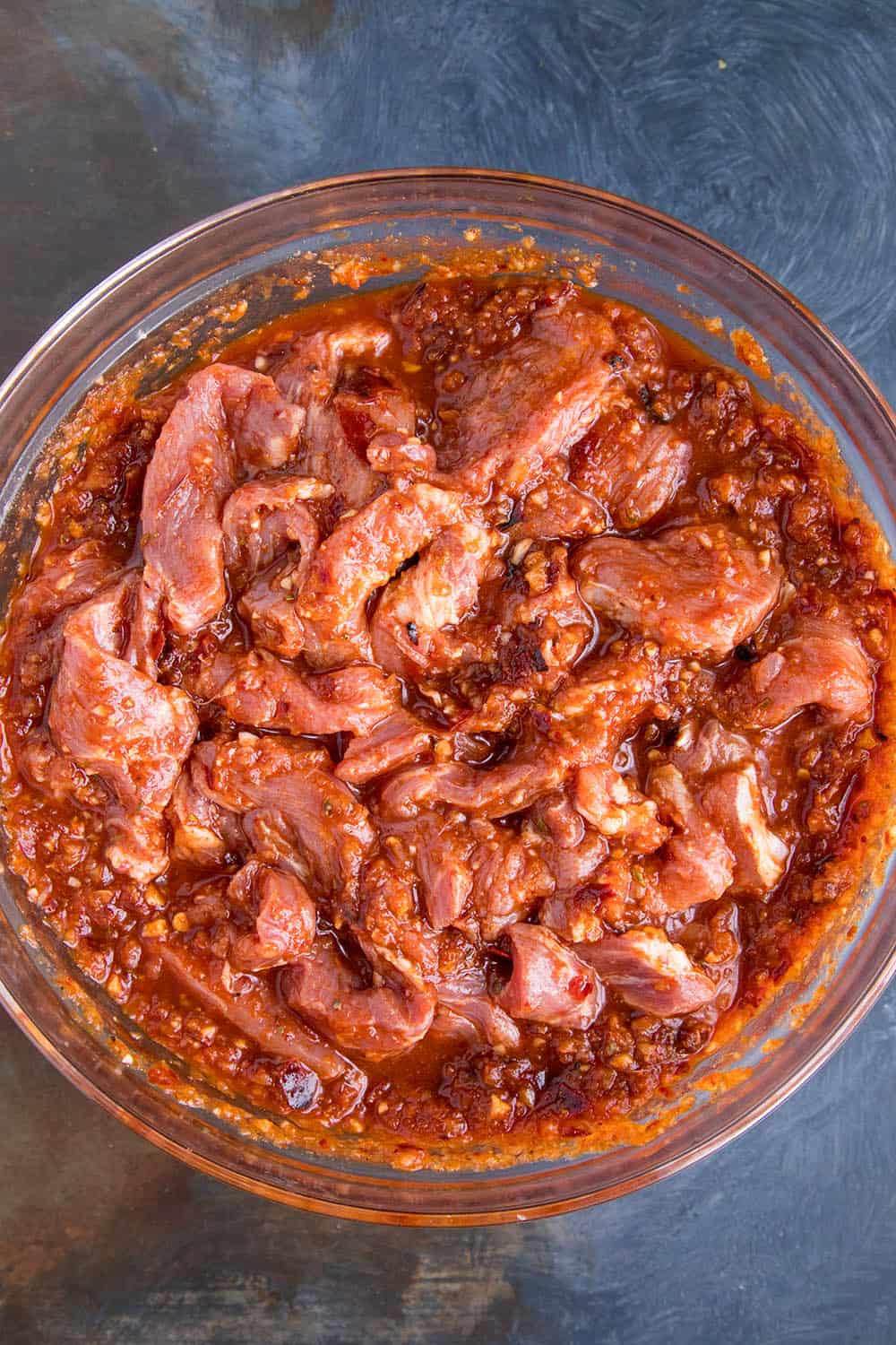 Marinating the pork to make tacos al pastor