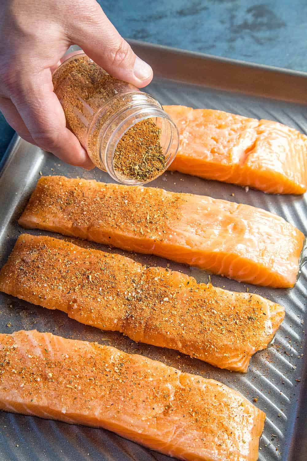 Seasoning the salmon with blackening seasoning