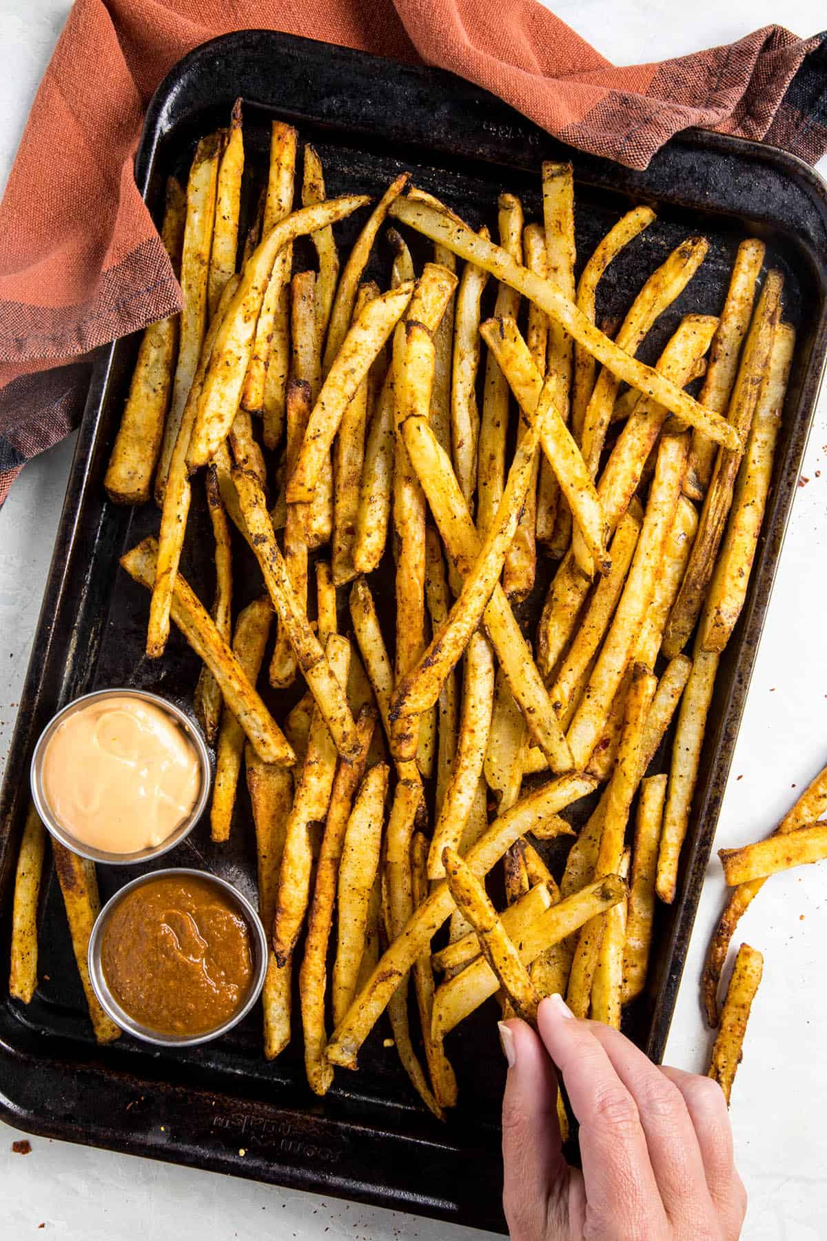 Snatching one of my Baked Cajun Fries off the tray