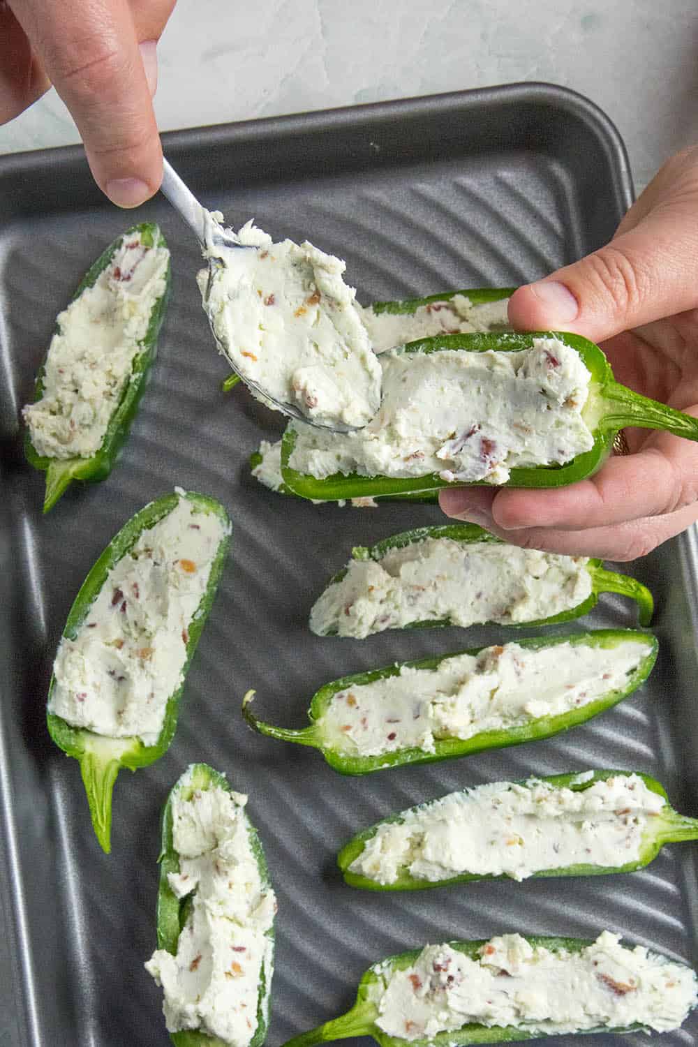 Stuffing a jalapeno popper with my blue cheese mixture.