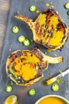 Grilled Pork Chops with Carolina Mustard BBQ Sauce on a platter, drizzled with sauce