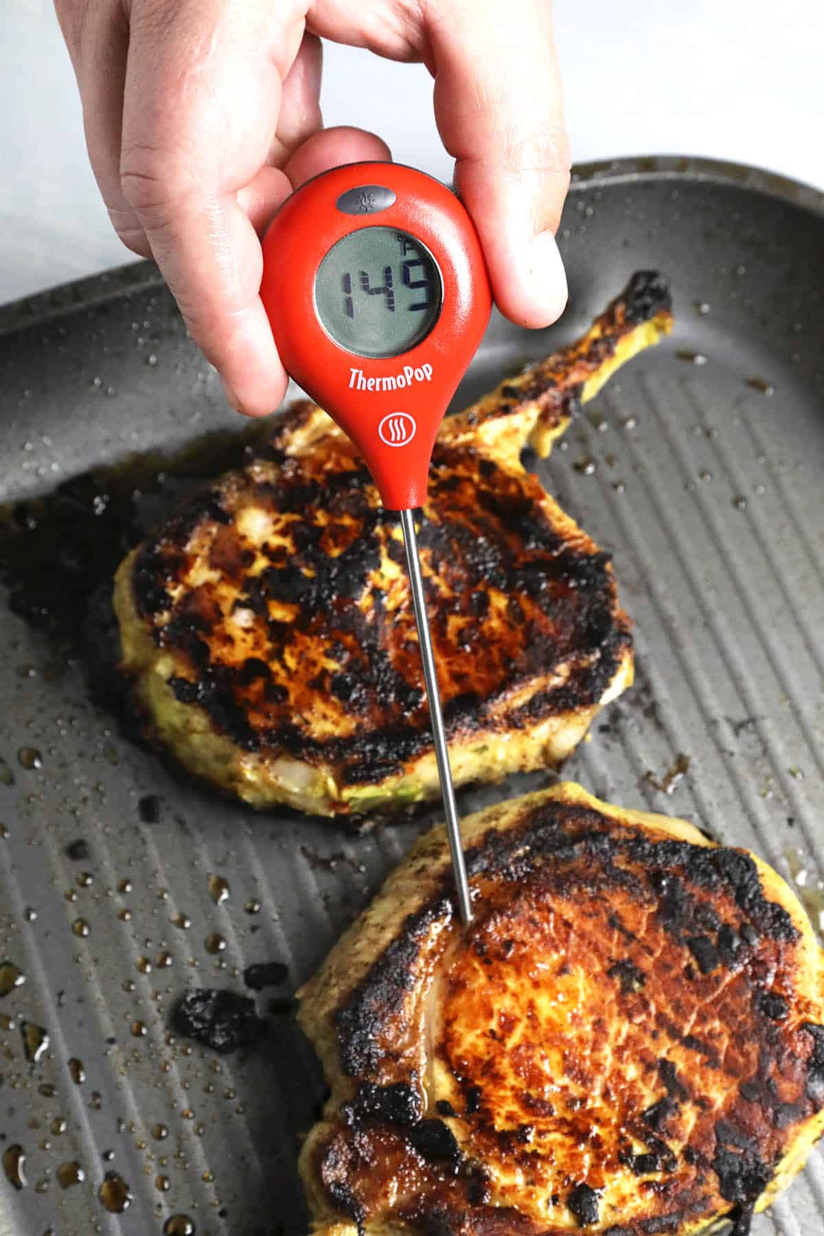 Checking the internal temperature of my grilled pork chops