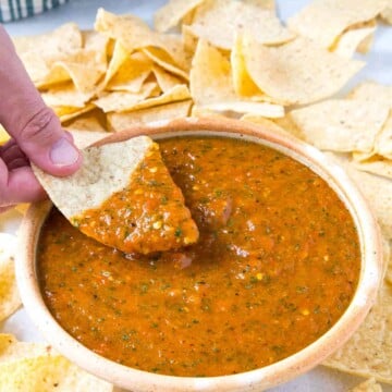 Dipping a chip into the Roasted Mango-Habanero Salsa.