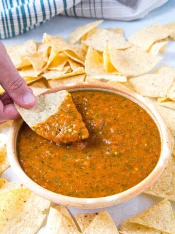 Dipping a chip into the Roasted Mango-Habanero Salsa.