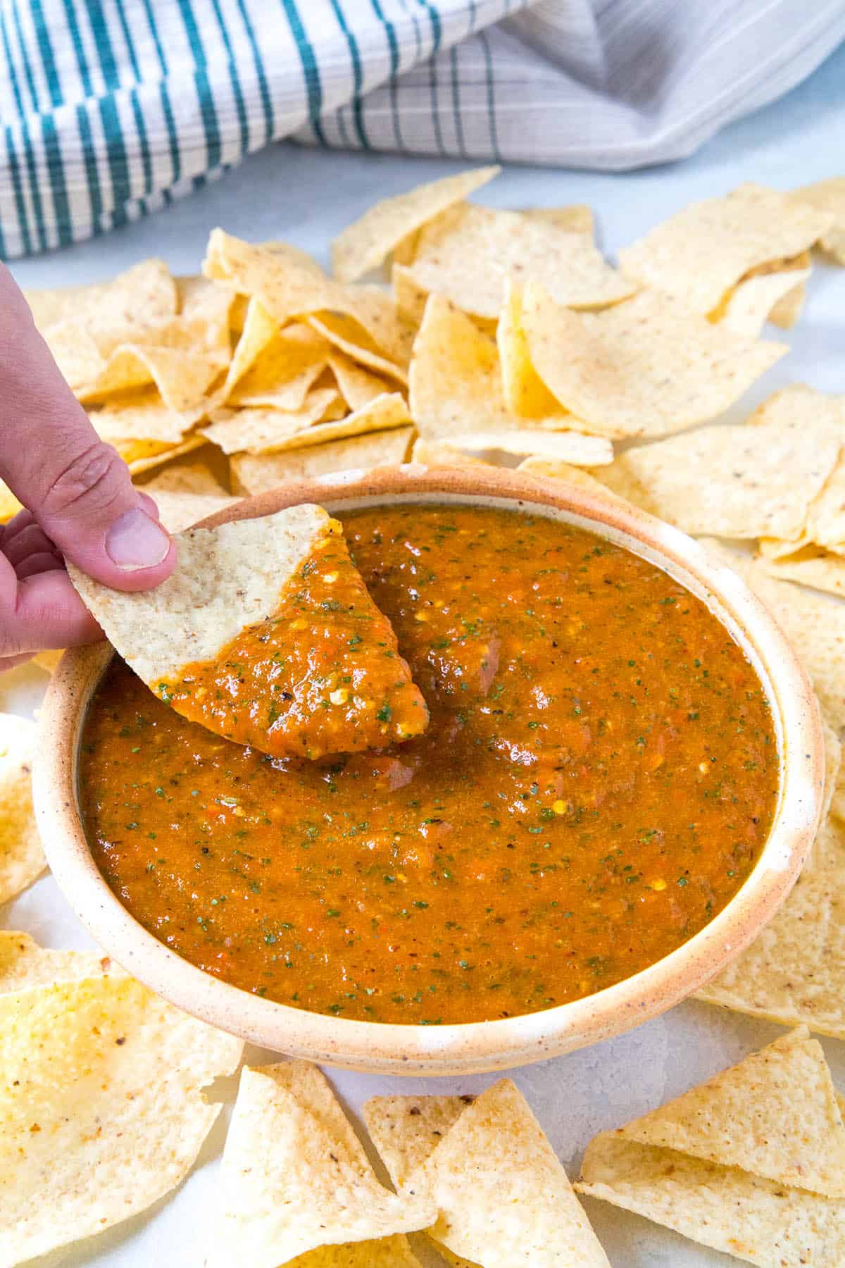 Dipping a chip into the Roasted Mango-Habanero Salsa.