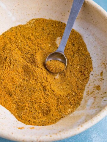 Curry Powder in a bowl, with a spoon