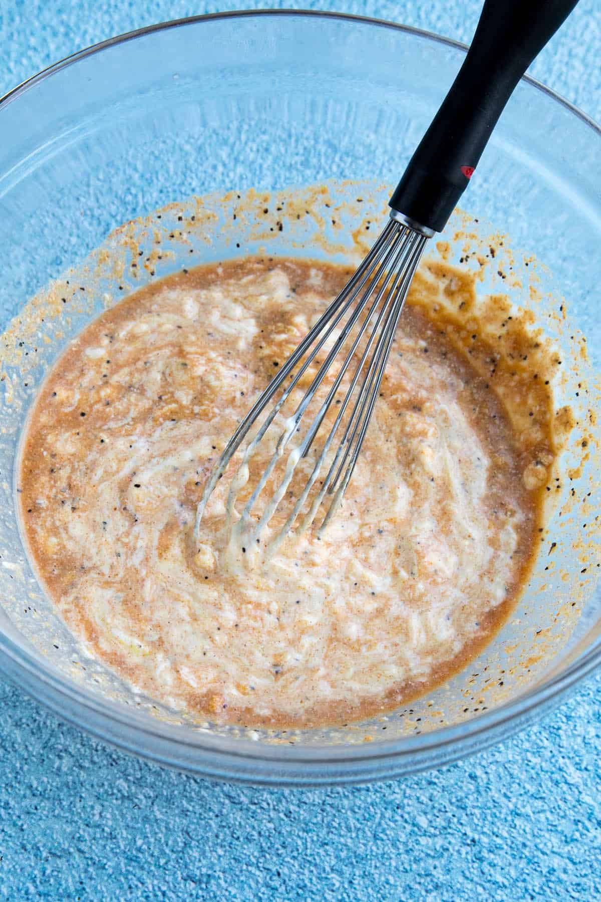 Whisking our Alabama White BBQ Sauce in a mixing bowl