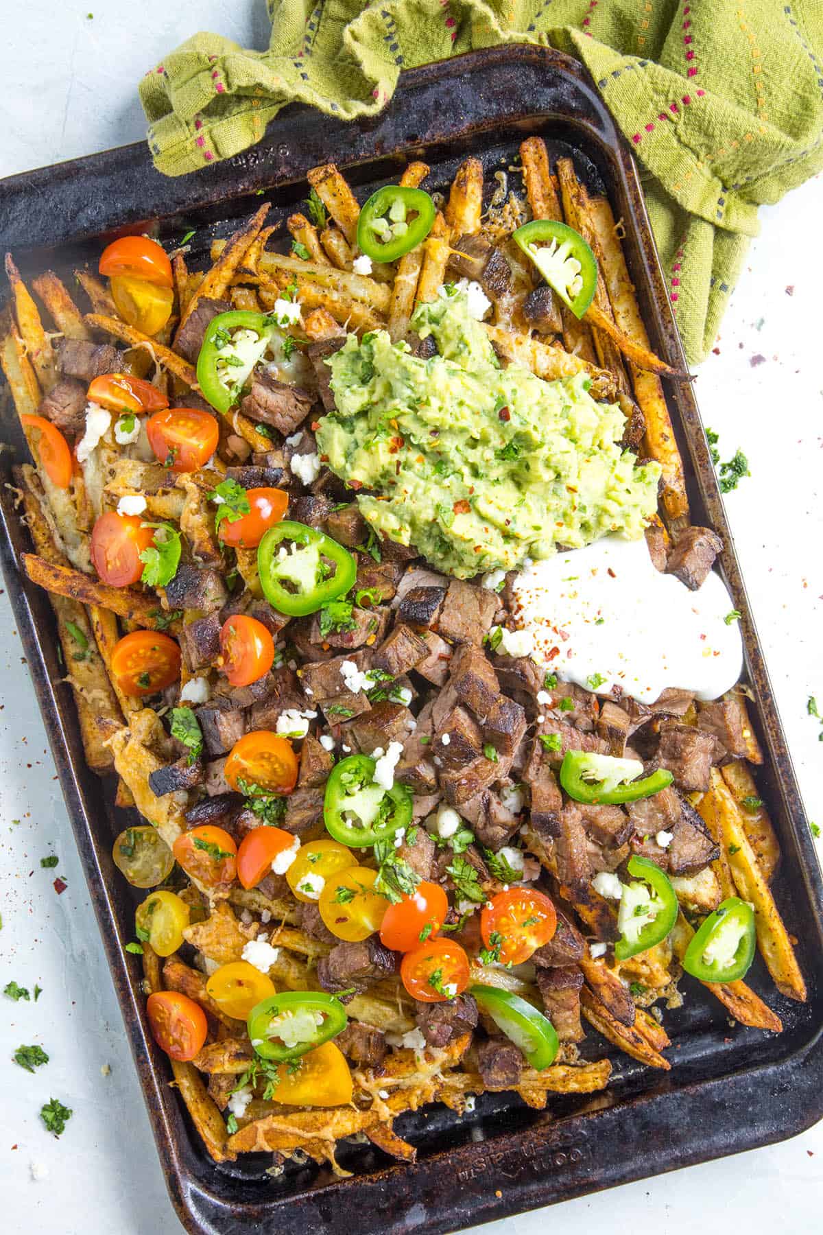 Carne Asada Fries on a baking sheet