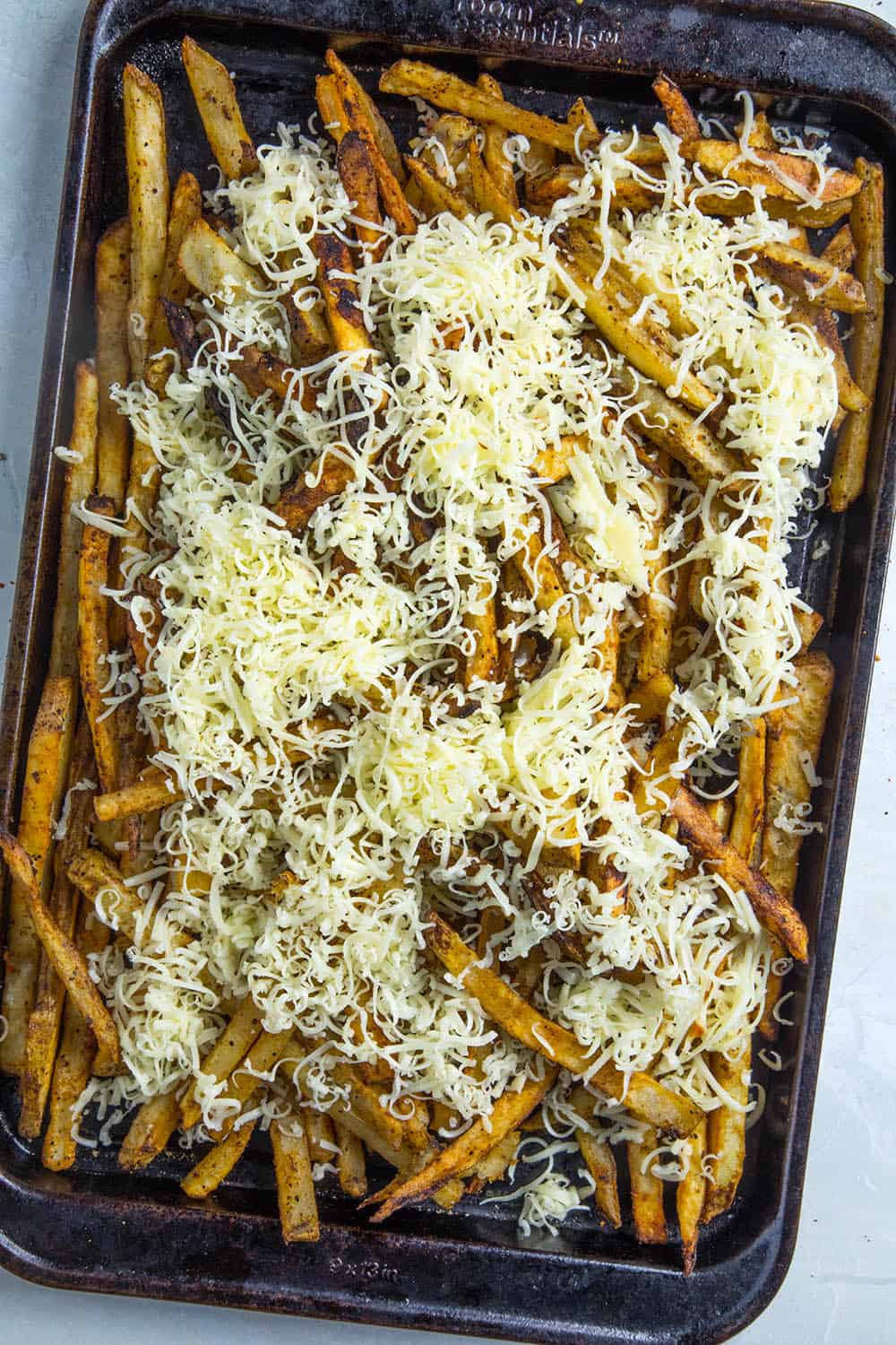 Topping the fries with cheese