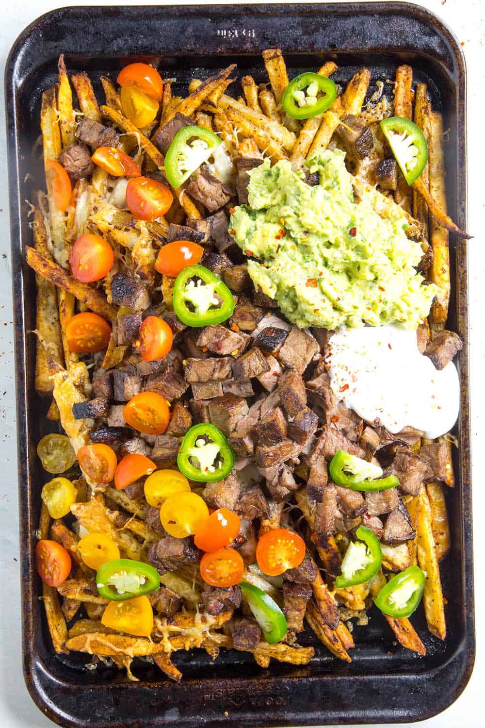 Carne Asada Fries on a baking sheet, ready to serve