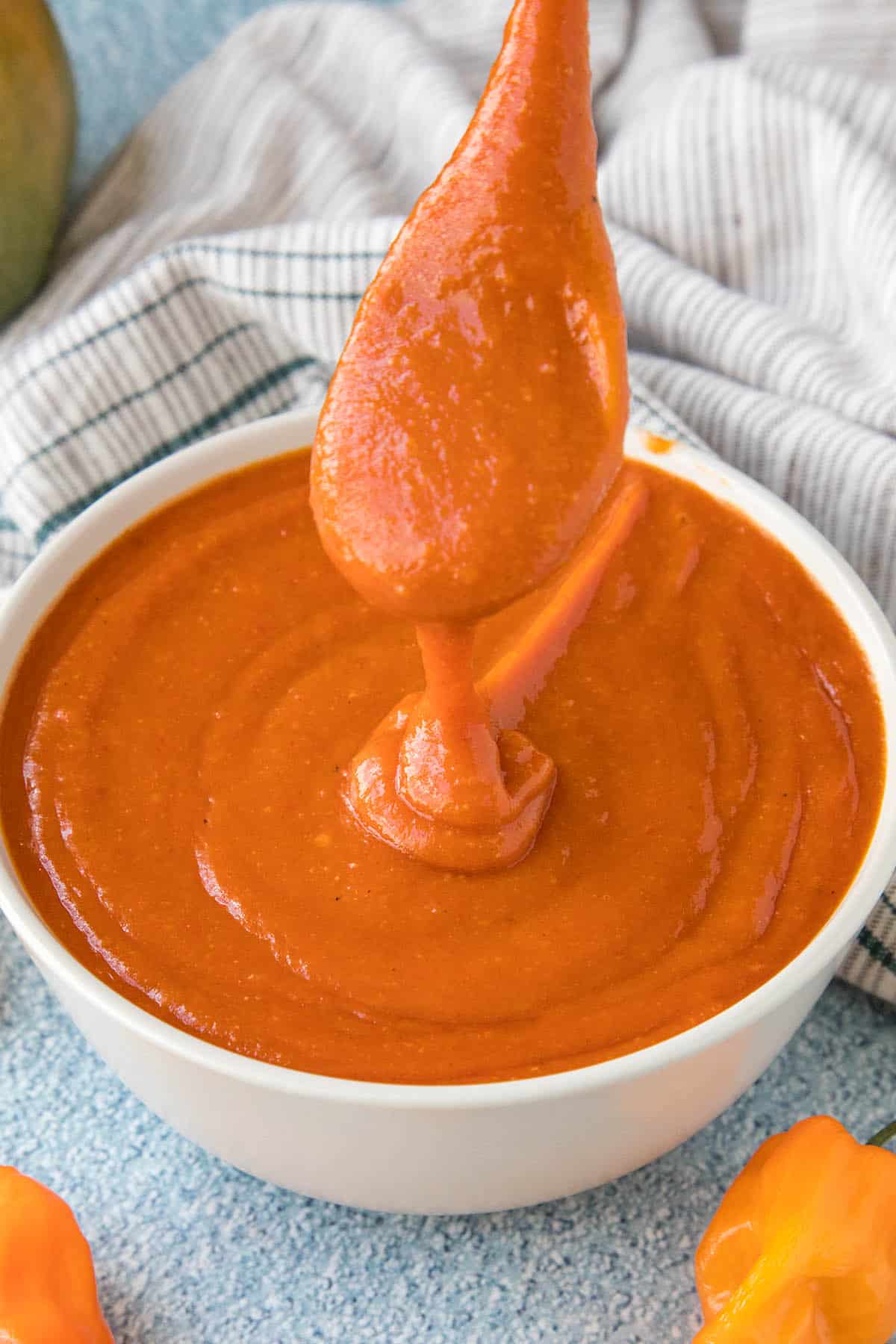 Mango Habanero BBQ Sauce dripping from a spoon. It's so thick!