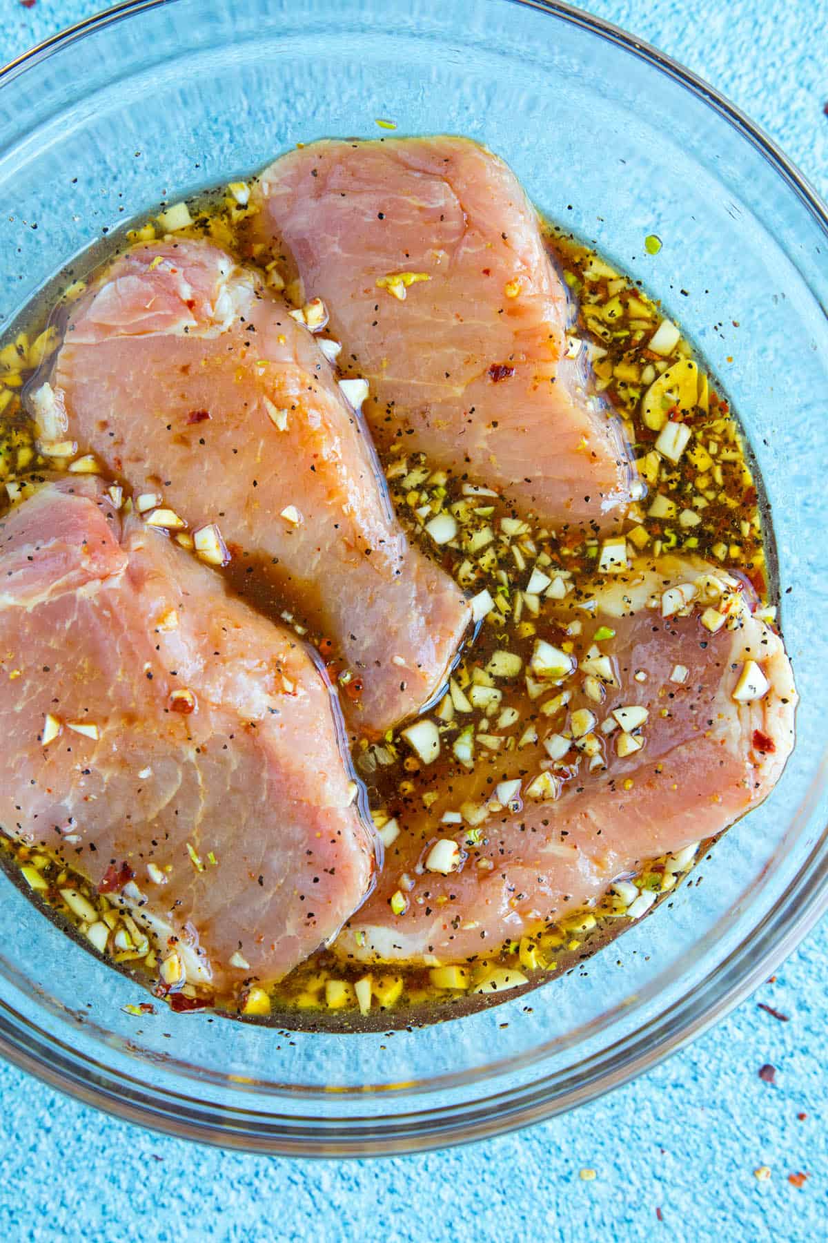Marinating the pork chops in a bowl