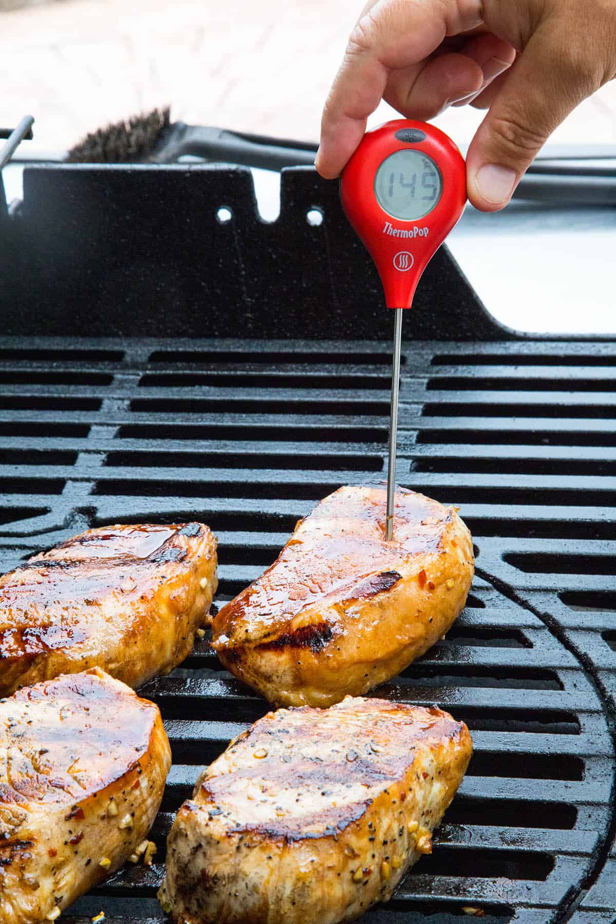 Measuring the internal temperature of our grilled pork chops
