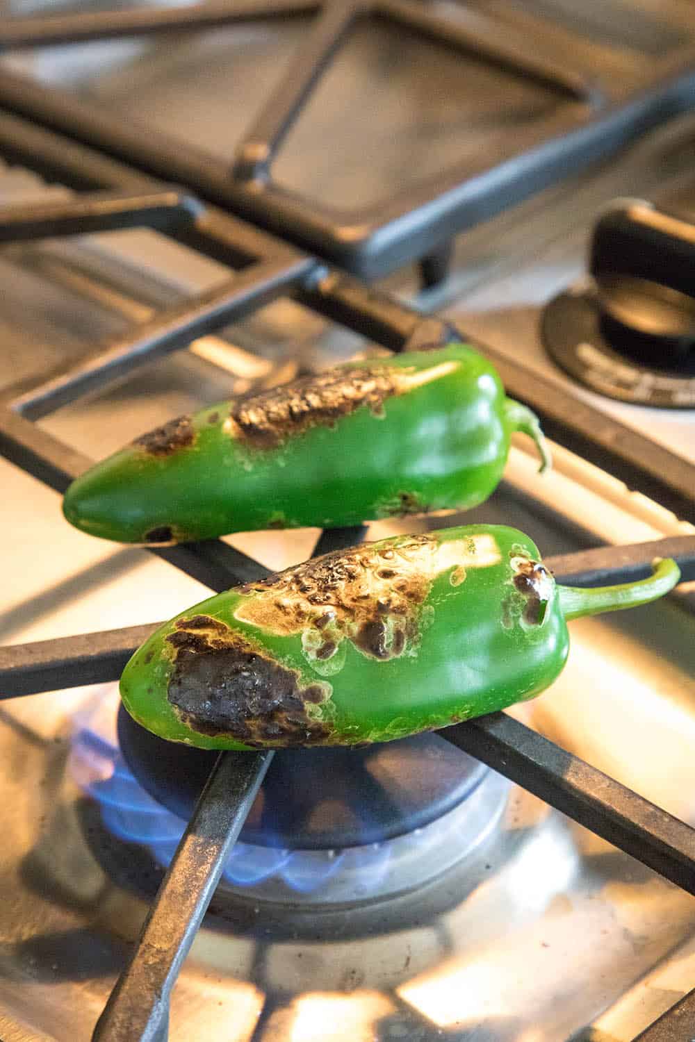 Roasting jalapeno peppers over an open flame