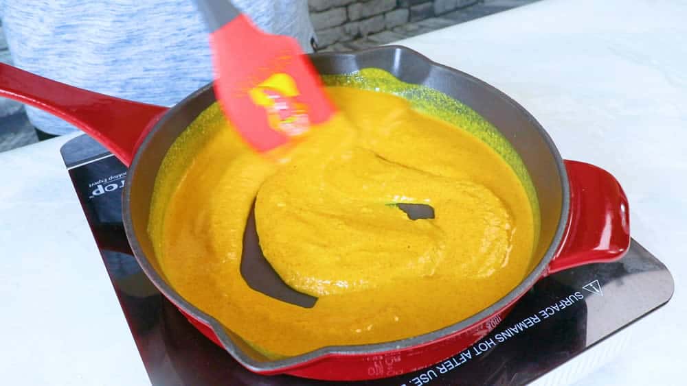 Stirring the mustard to thicken over heat