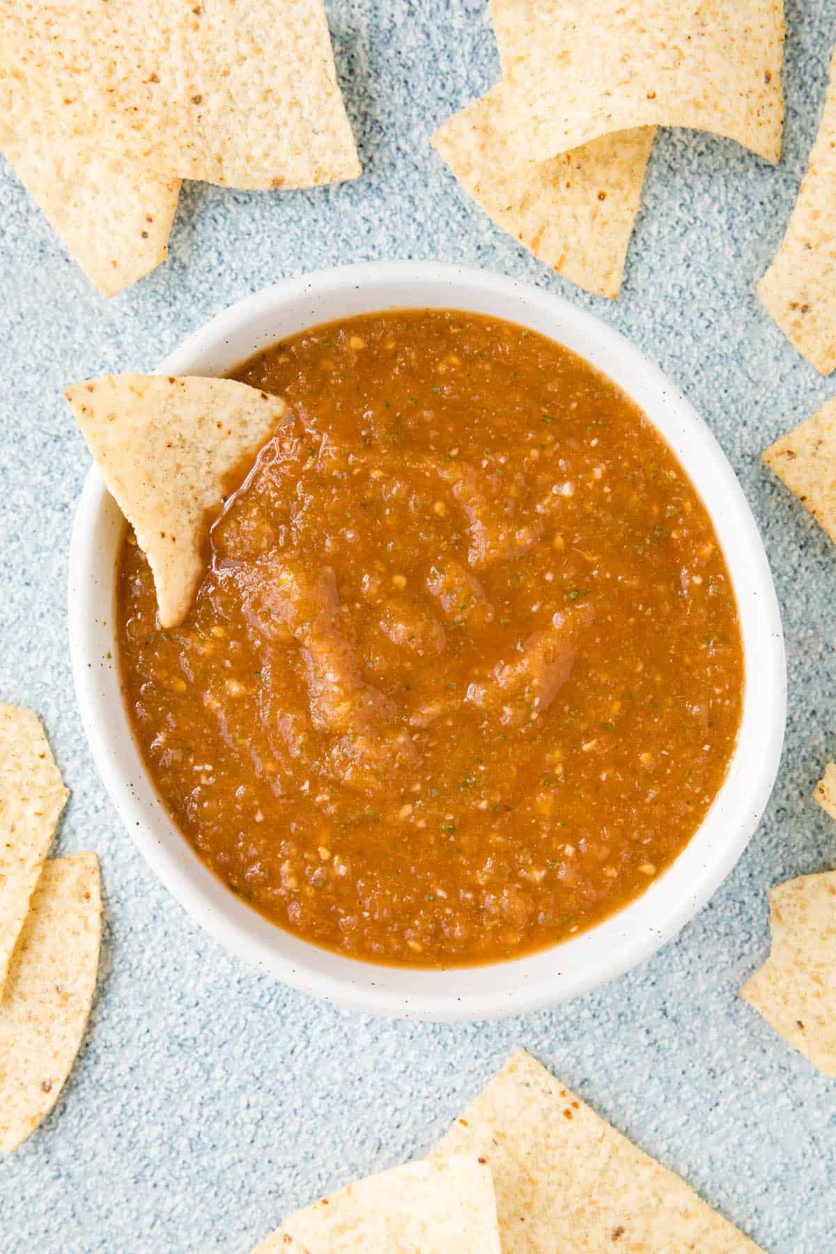 Salsa Ranchera in a bowl with a chip