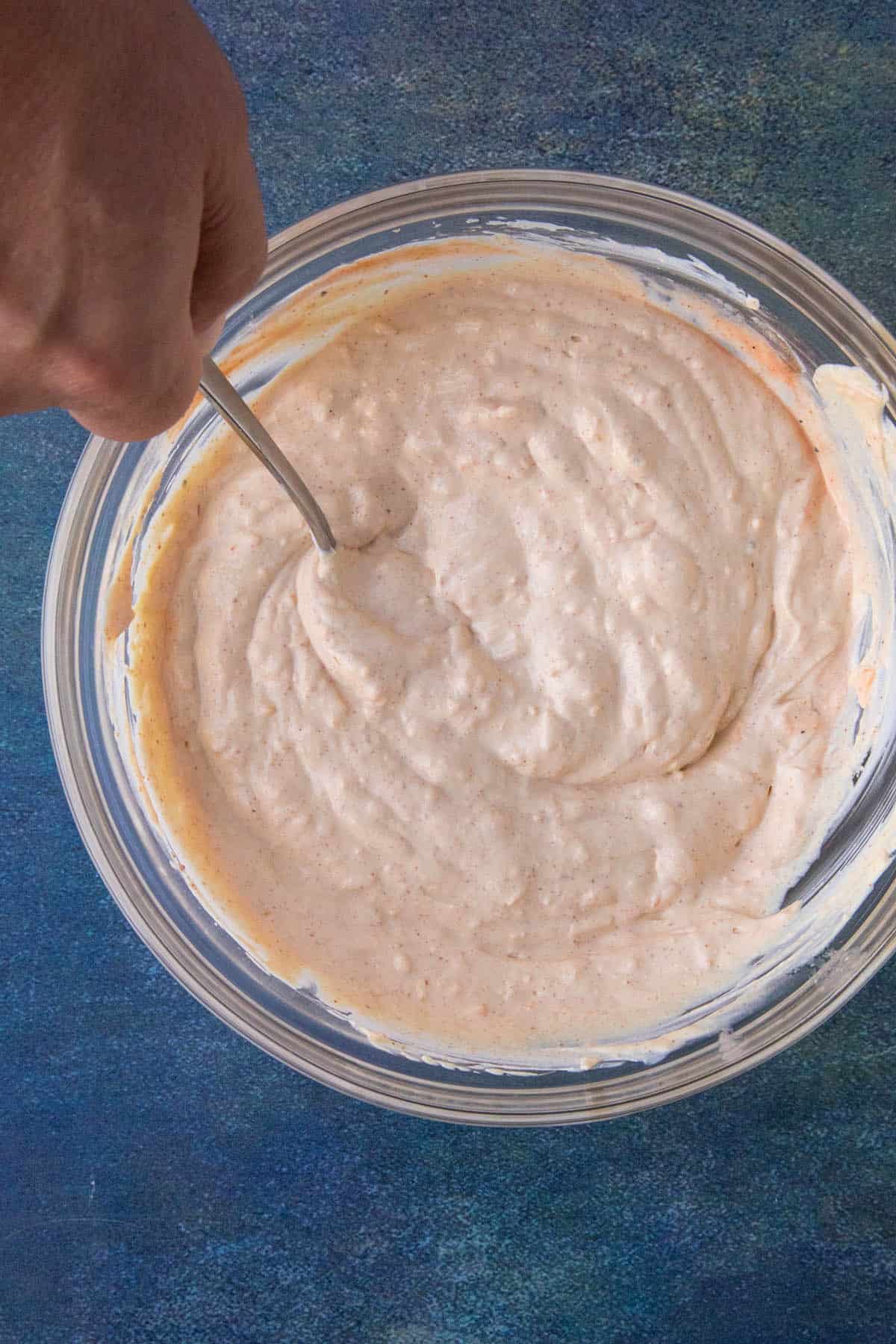 Mixed sour cream dip in a bowl.