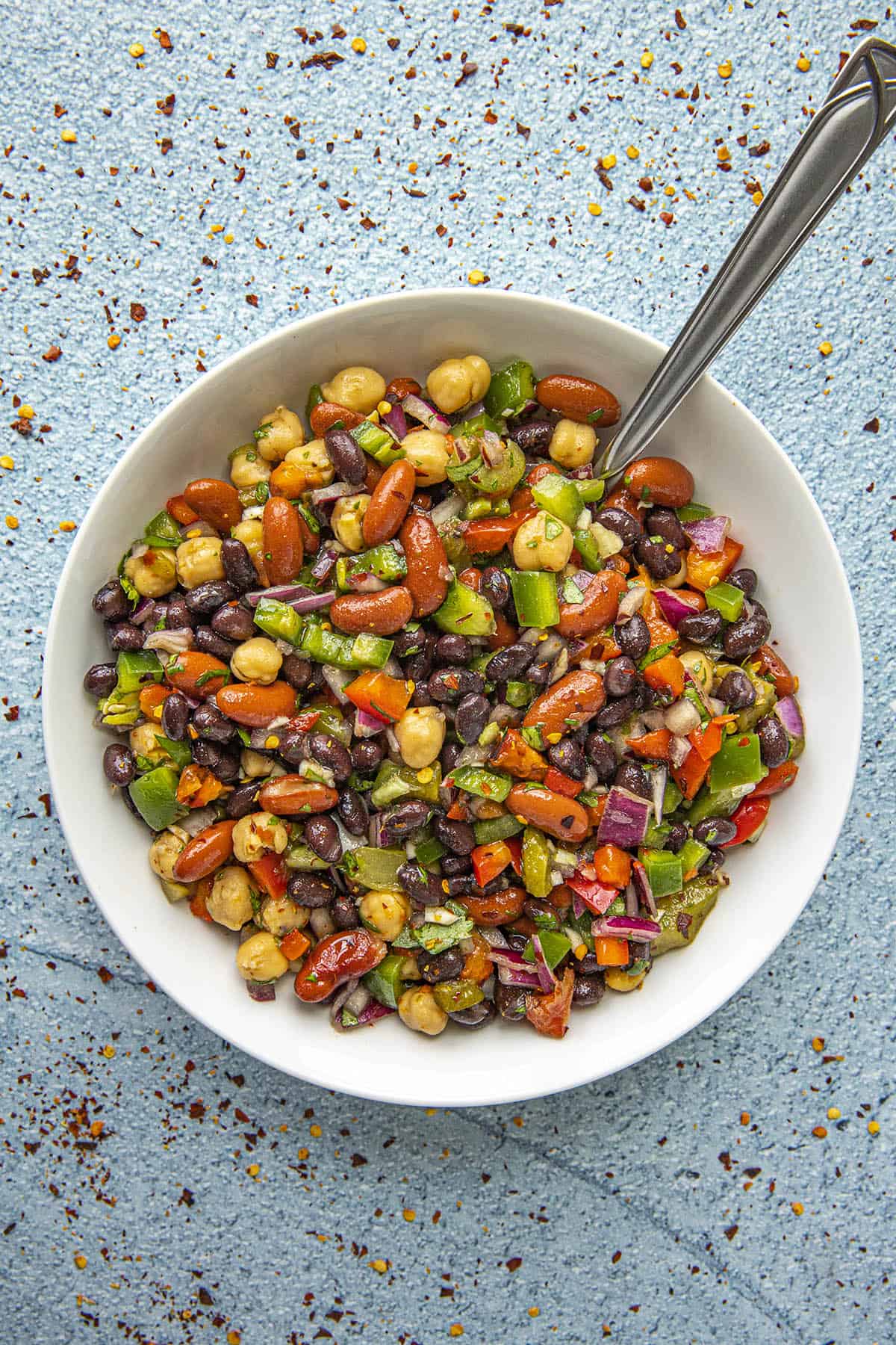 Three Bean Salad in a bowl with a serving spoon