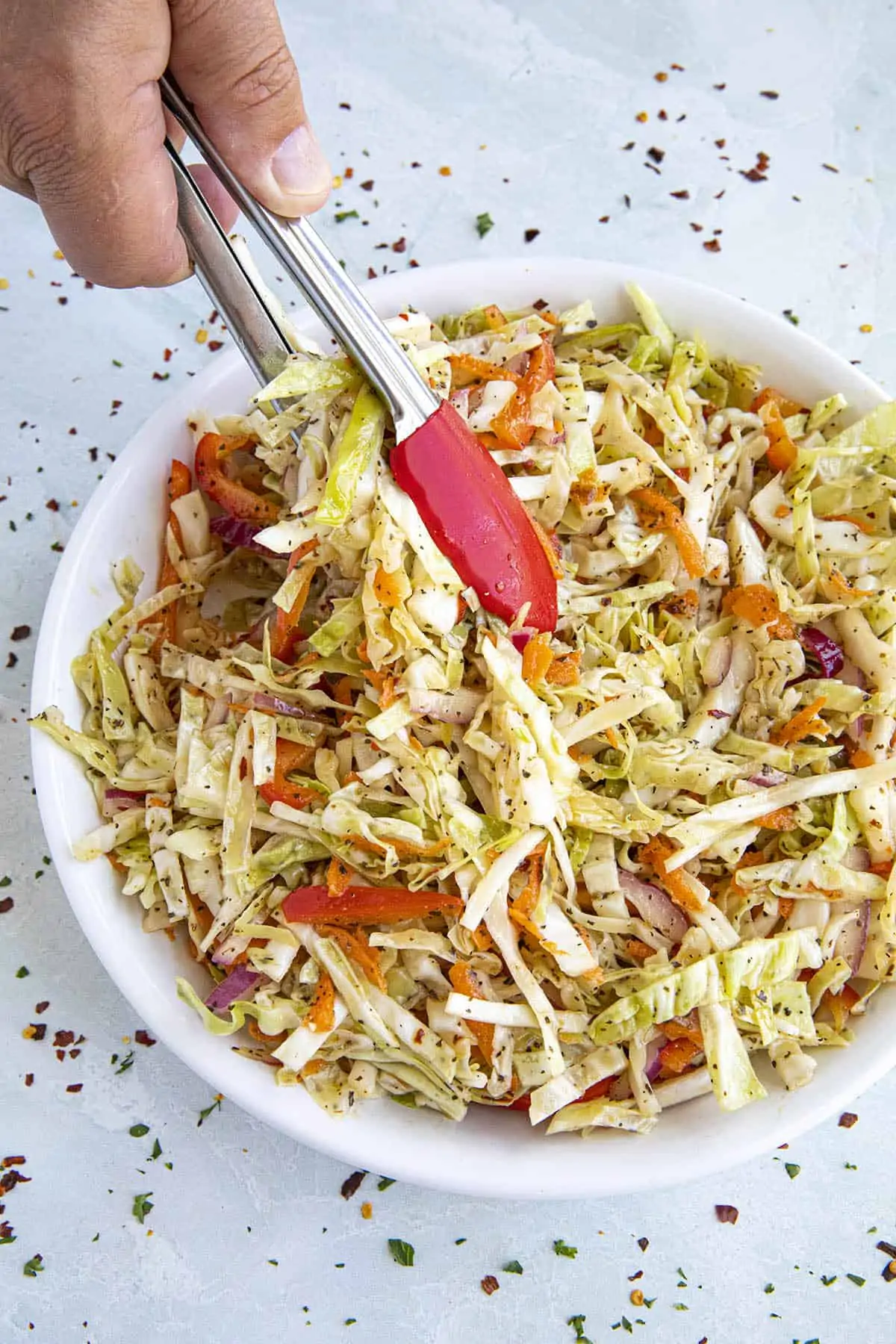 Serving Vinegar Coleslaw with tongs