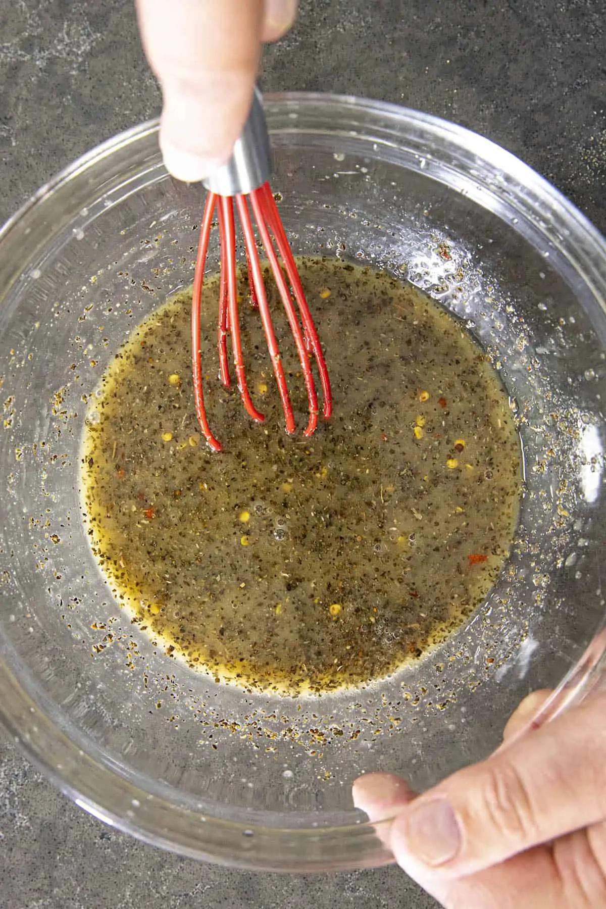 Whisking the vinaigrette to make Vinegar Coleslaw