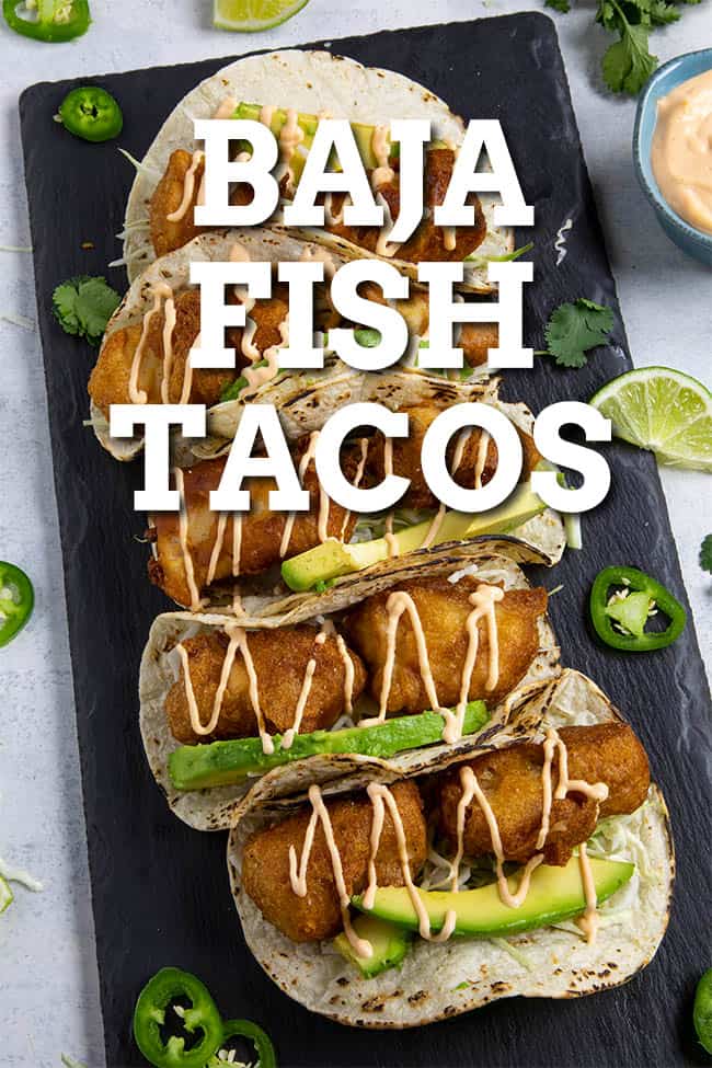 Baja Fish Tacos Recipe - This Baja fish tacos recipe serves up fresh mahi mahi coated with beer batter and fried golden, topped with crunchy slaw and homemade creamy fish taco sauce. Perfect tacos! #Tacos #Seafood