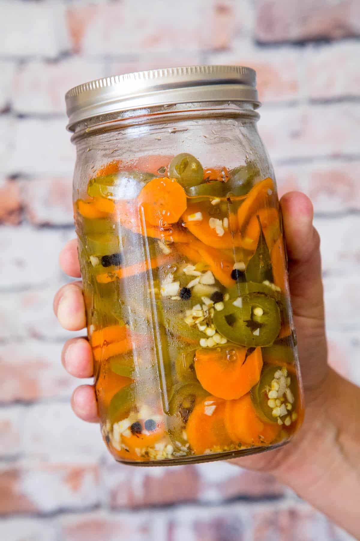 Pickled jalapenos and carrots in a jar