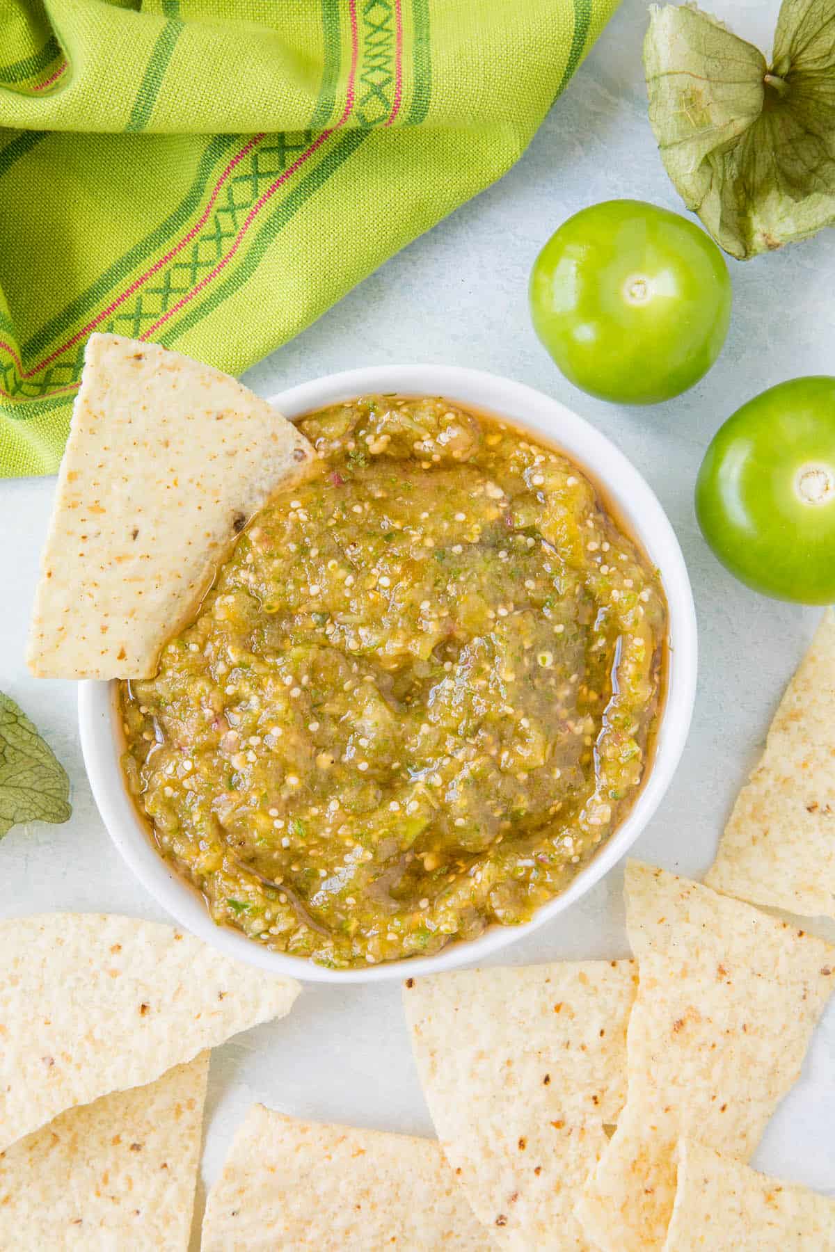Salsa verde in a bowl with a chip