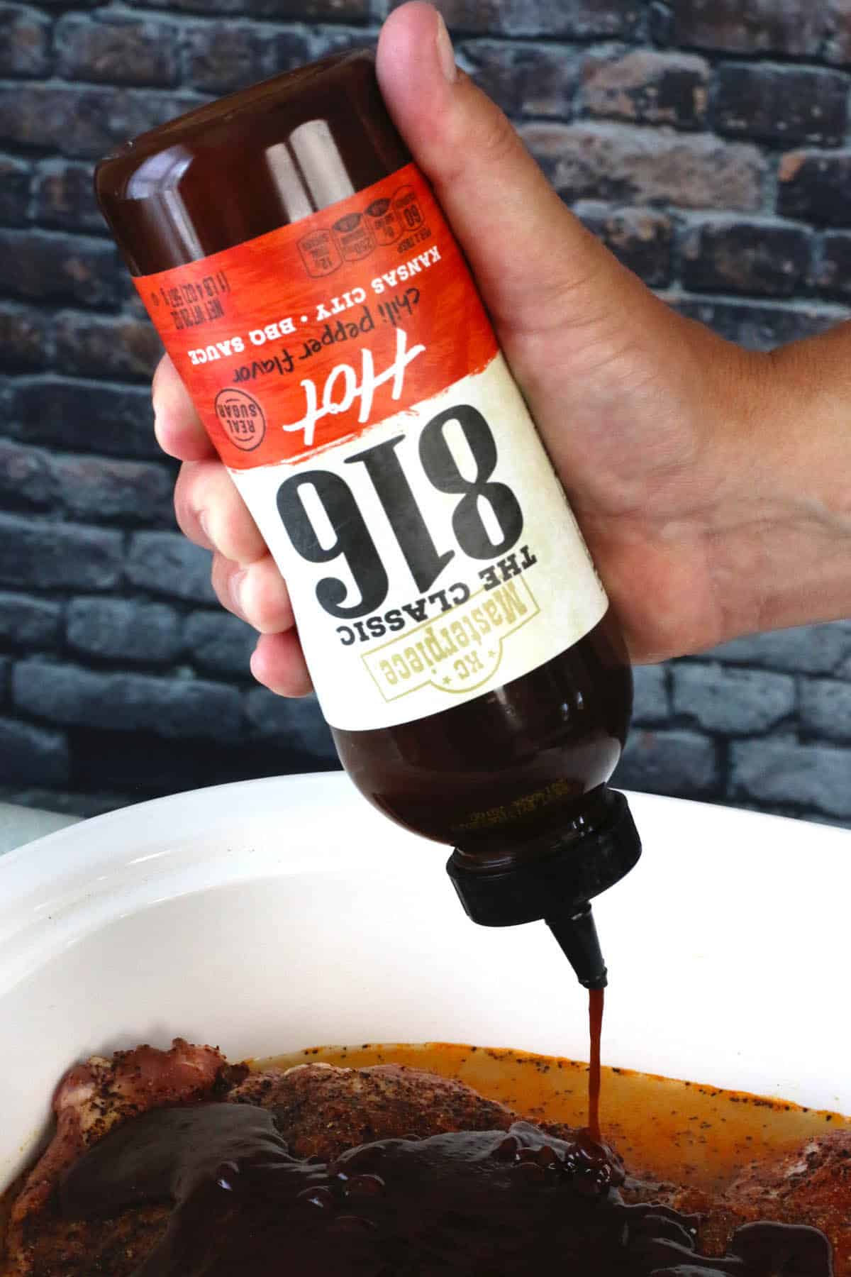 Pouring KC Masterpiece® 816 Hot BBQ Sauce.