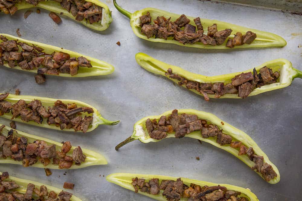 Stuffing the banana peppers with meat