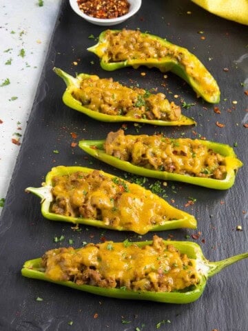 Turkey and Cheddar Stuffed Anaheim Peppers served on a board