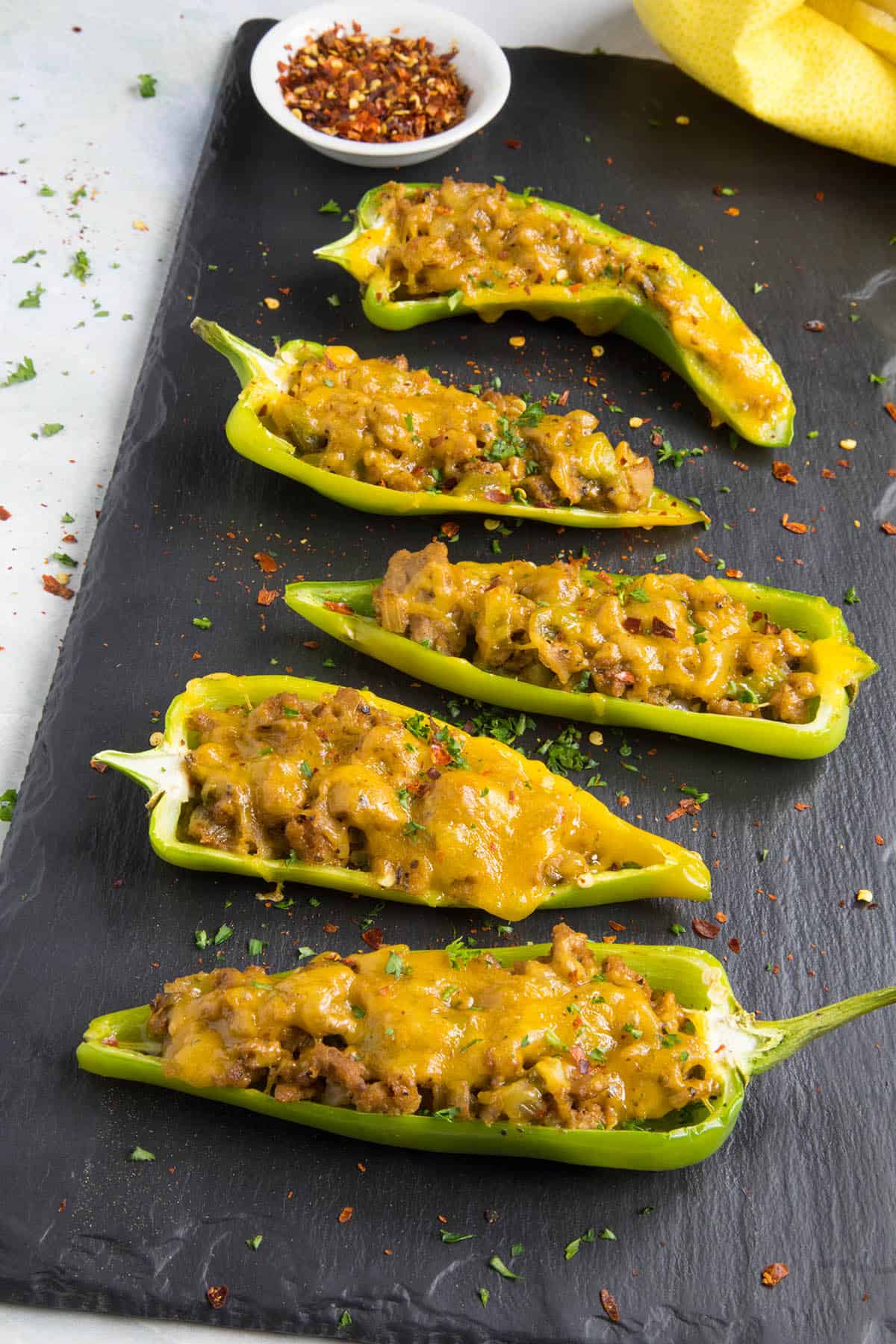 Turkey and Cheddar Stuffed Anaheim Peppers served on a board