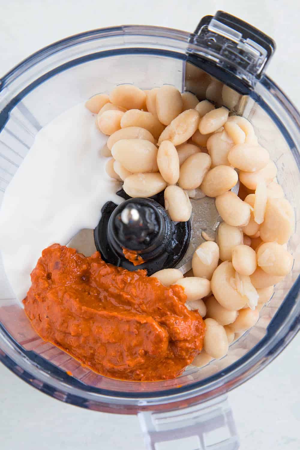 Ingredients for my Creamy White Bean Dip with Harissa in the food processor