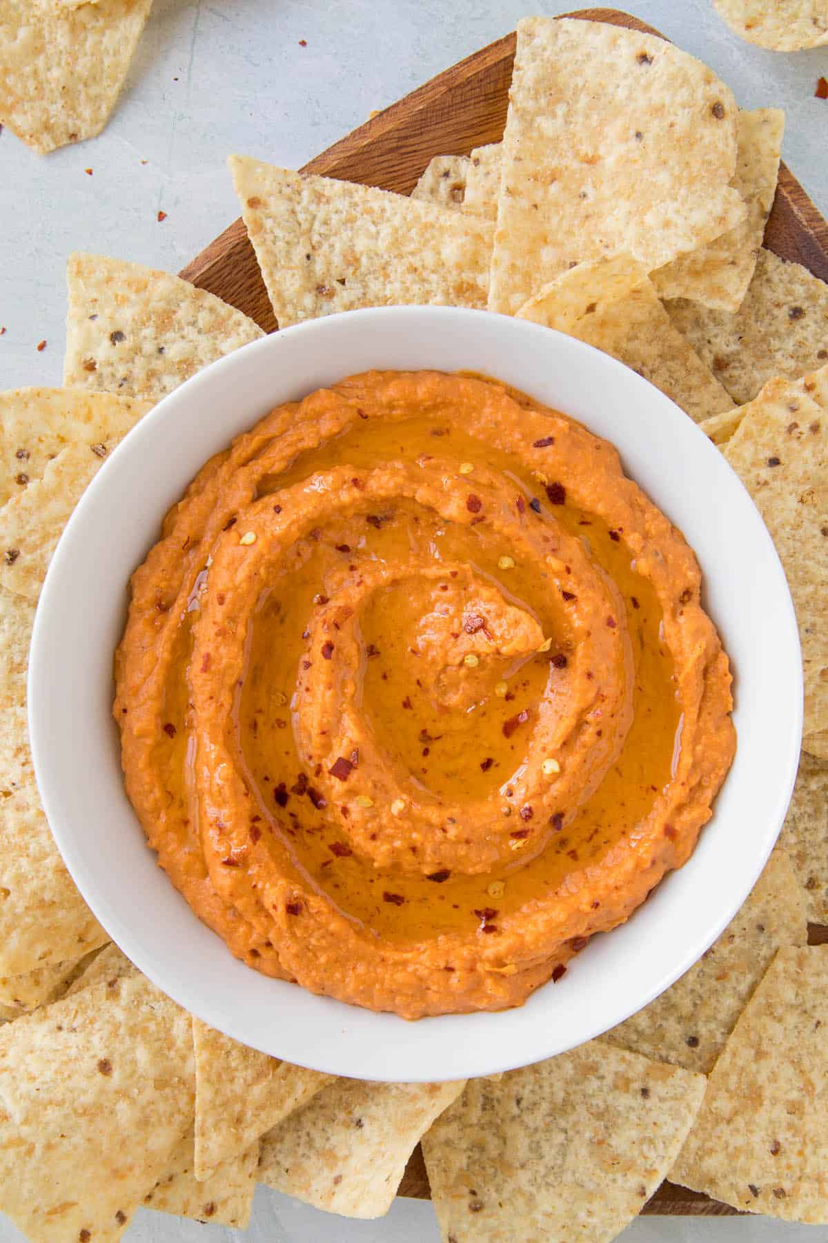 Creamy White Bean Dip with Harissa in a bowl with garnish