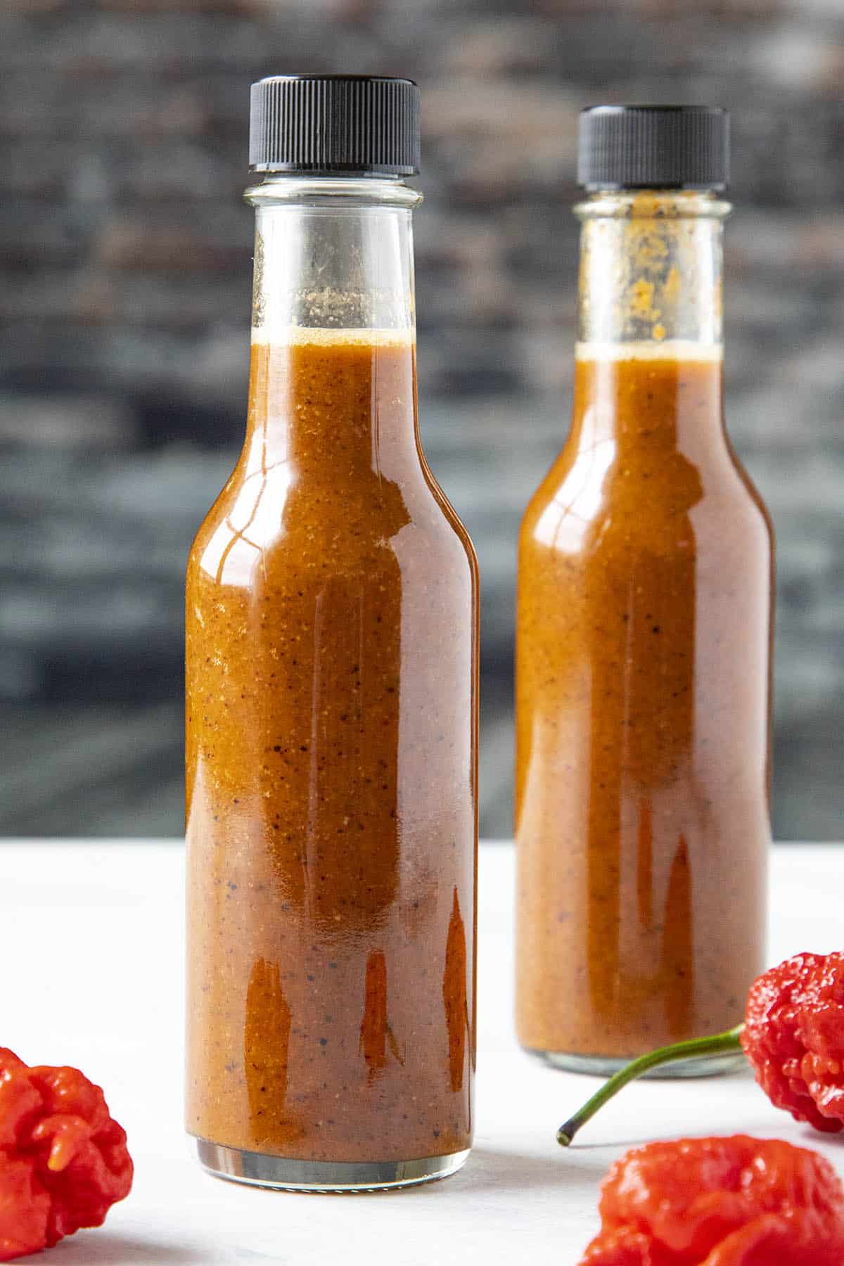 Two bottles of Carolina Reaper Hot Sauce